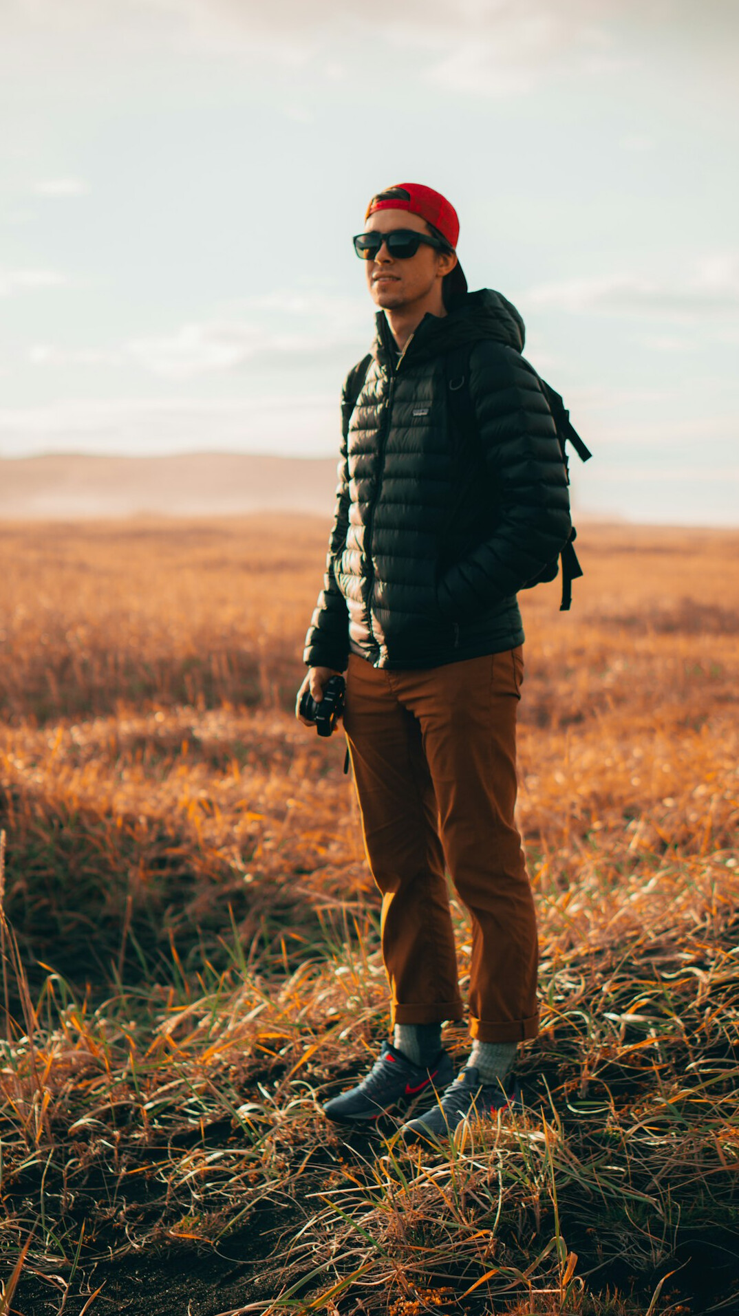 Photographer holding a camera while working in the field
