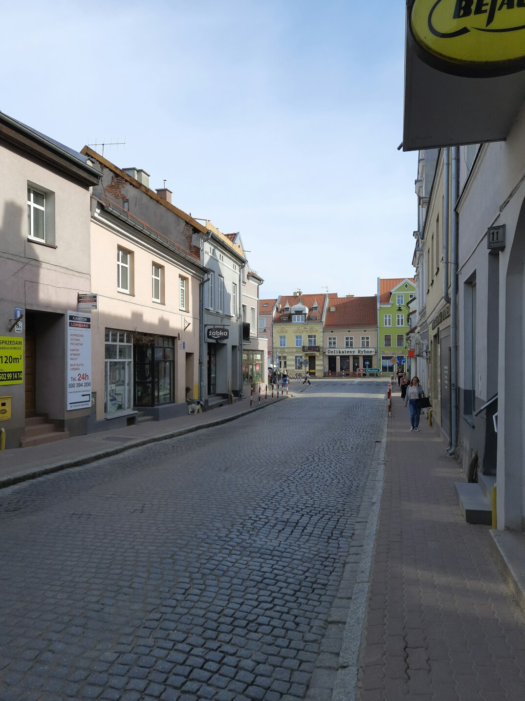 Street scene in a small Polish town with residents going about daily life