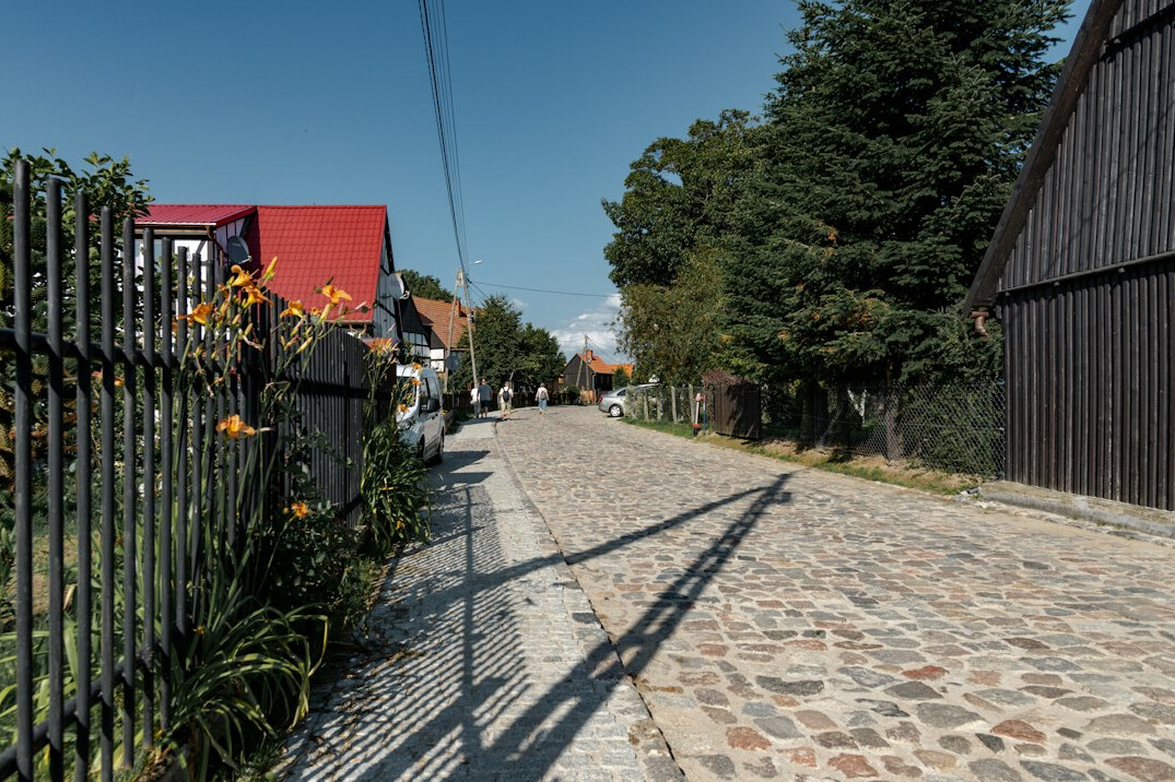 Narrow street in a small Polish village with old houses