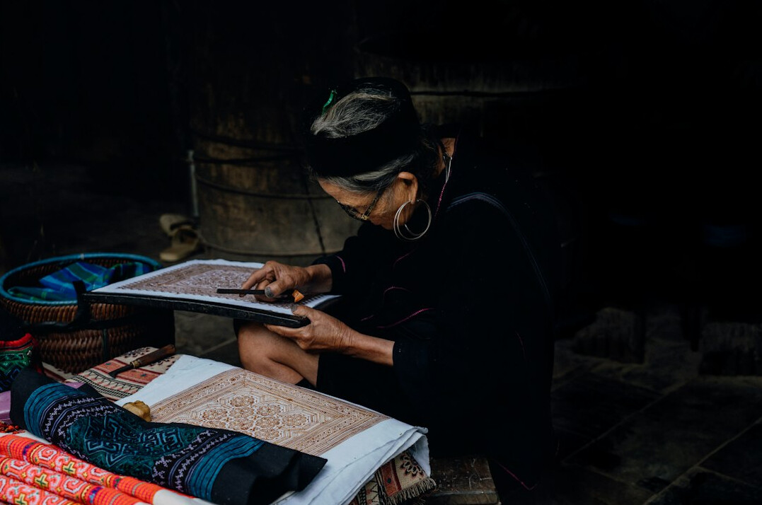 woman sewing traditional clothes